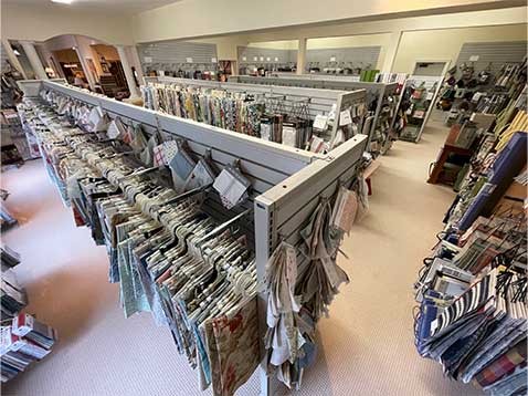A room full of fabric samples on hangers