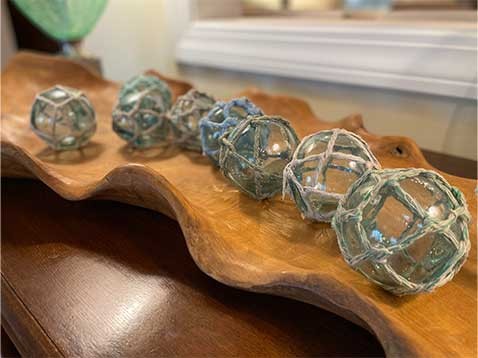 Glass balls wrapped in twine sitting on a display